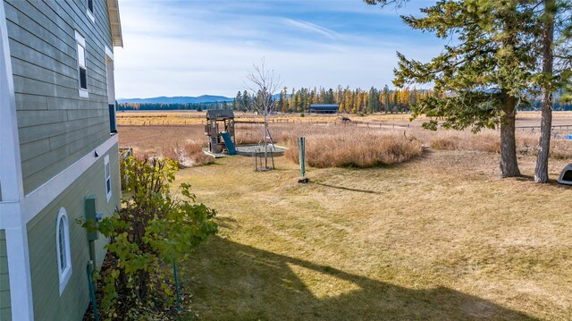 view of yard featuring a rural view and a mountain view