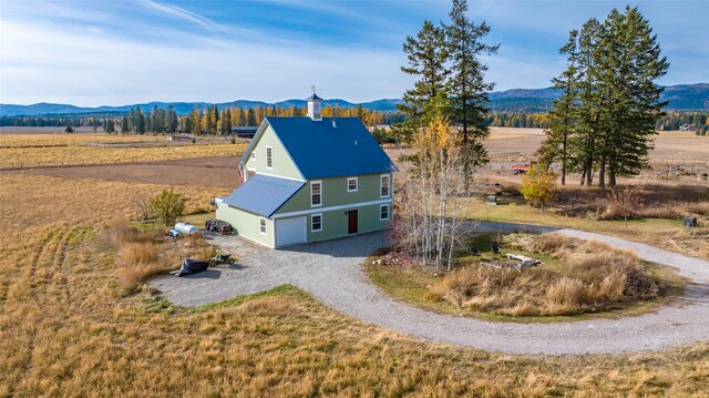 drone / aerial view featuring a mountain view and a rural view