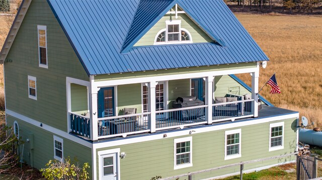 rear view of property with a balcony