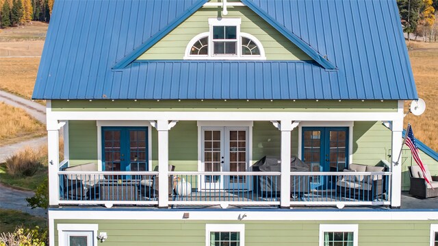 back of house with french doors and covered porch