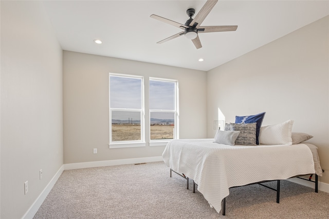 bedroom with ceiling fan and light carpet