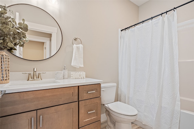 full bathroom with vanity, shower / bath combination with curtain, and toilet