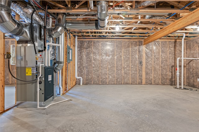 basement with electric panel and heating unit