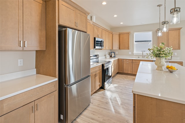 kitchen featuring sink, decorative light fixtures, light wood-type flooring, light brown cabinetry, and appliances with stainless steel finishes