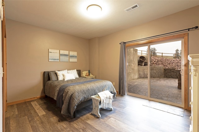 bedroom featuring access to exterior and wood-type flooring