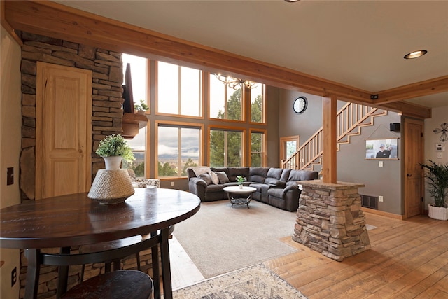 living room with beam ceiling and light wood-type flooring