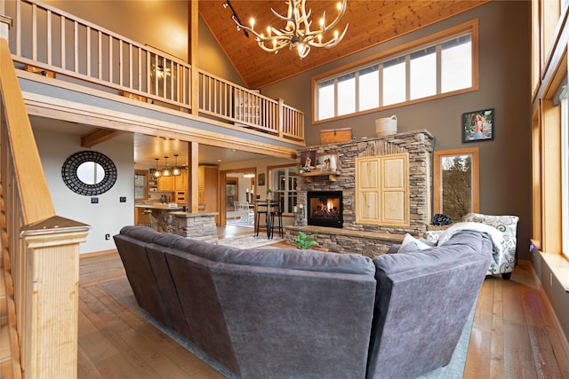 living room featuring a stone fireplace, wooden ceiling, high vaulted ceiling, and wood-type flooring