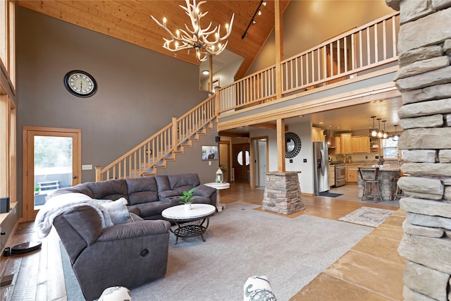 living room with wood ceiling, light wood-type flooring, and high vaulted ceiling