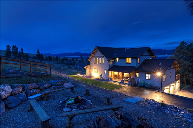 rear view of property featuring a mountain view and a garage