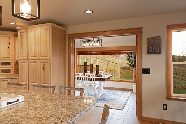 tiled dining room with a wealth of natural light