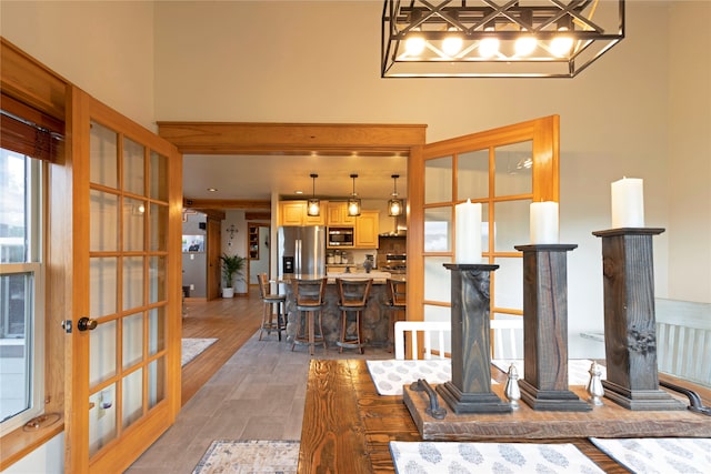 living room with hardwood / wood-style flooring and a high ceiling