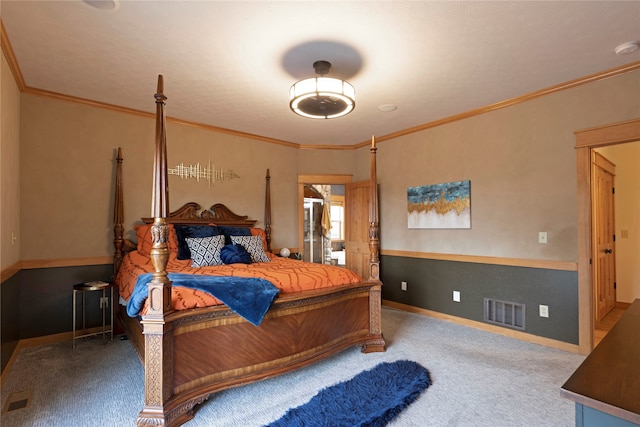 bedroom with ornamental molding and carpet floors