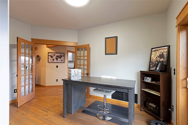 office space featuring french doors and light hardwood / wood-style floors