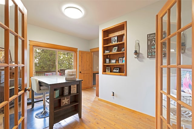 dining area featuring french doors and light hardwood / wood-style flooring