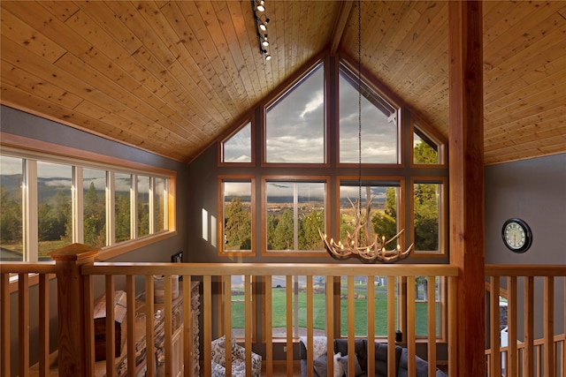 details with rail lighting, a notable chandelier, and wooden ceiling