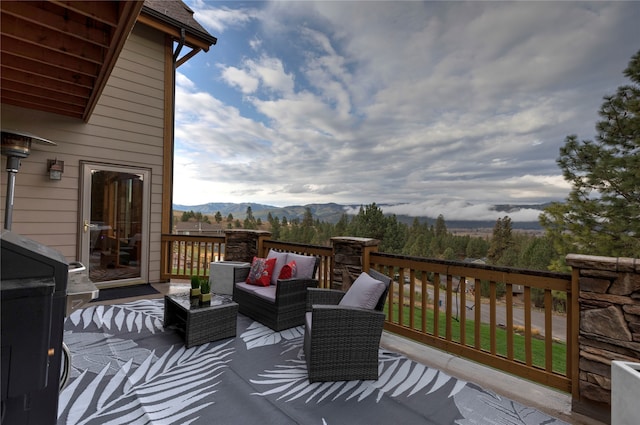 deck with an outdoor hangout area and a mountain view