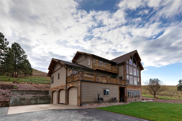 view of side of home featuring a garage and a balcony