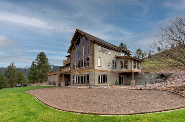 rear view of property with a patio and a lawn