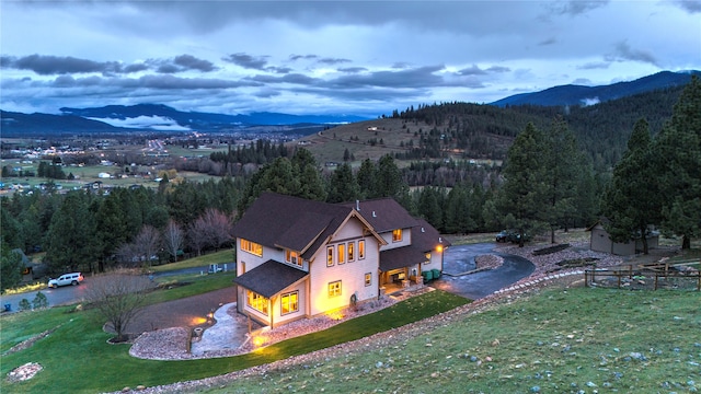 aerial view at dusk featuring a mountain view