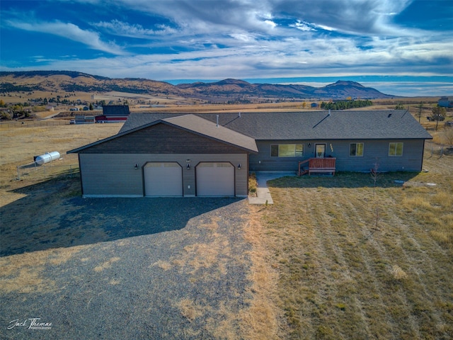 ranch-style house featuring a mountain view and a garage