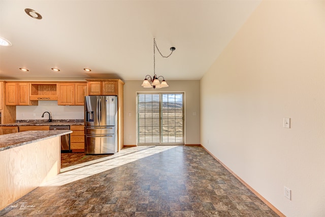 kitchen featuring hanging light fixtures, sink, light brown cabinetry, a chandelier, and appliances with stainless steel finishes