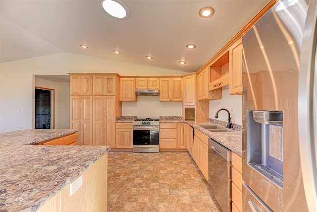 kitchen with light brown cabinets, stainless steel appliances, sink, and vaulted ceiling