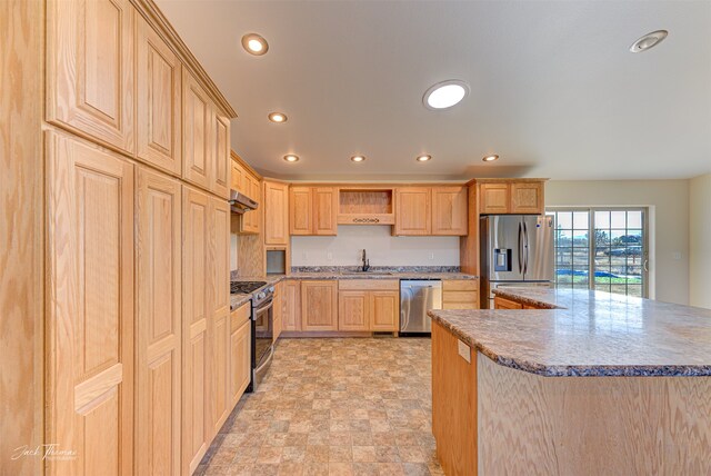 kitchen featuring range hood, appliances with stainless steel finishes, sink, and light brown cabinets