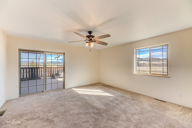 empty room featuring carpet and ceiling fan