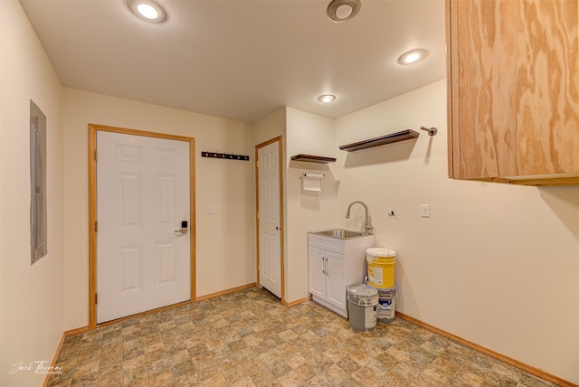 clothes washing area featuring sink