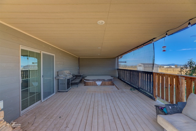 deck with a mountain view and area for grilling