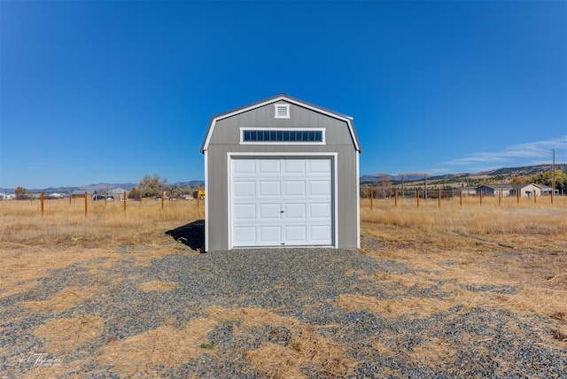 garage featuring a rural view and a mountain view