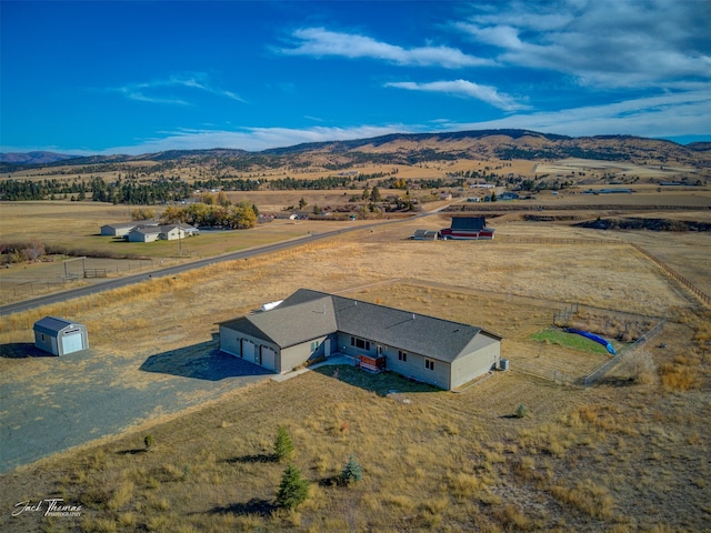 birds eye view of property featuring a mountain view and a rural view