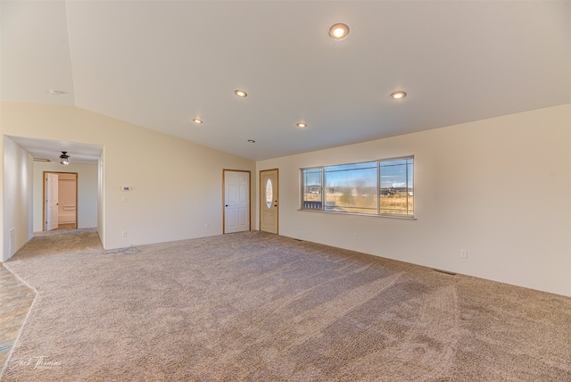 carpeted empty room featuring lofted ceiling and ceiling fan