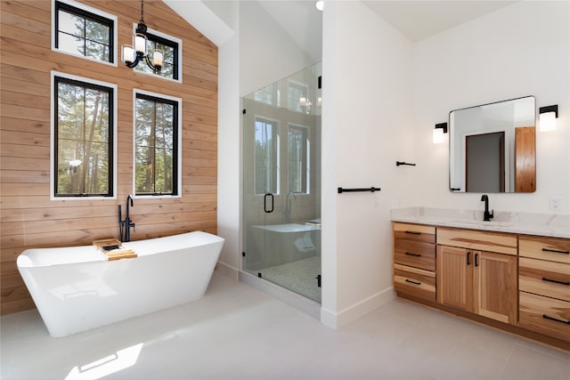 bathroom featuring vanity, separate shower and tub, wooden walls, and plenty of natural light