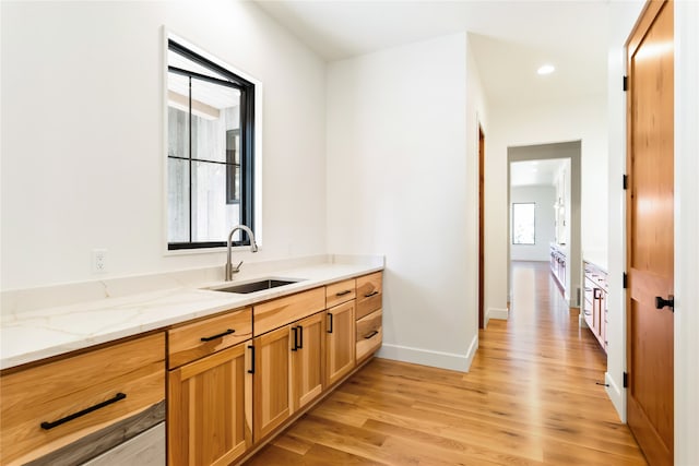 interior space featuring vanity, hardwood / wood-style floors, and plenty of natural light