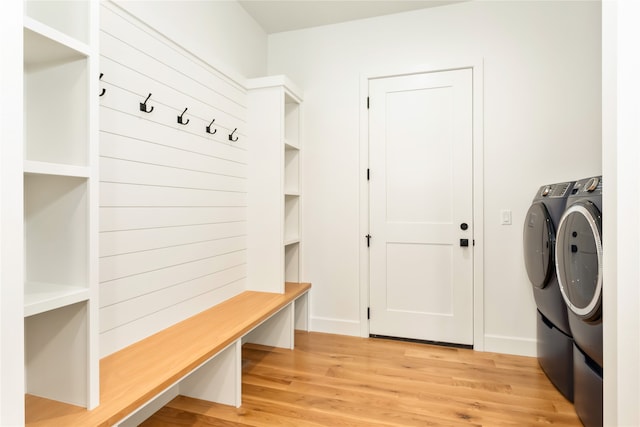 mudroom with independent washer and dryer and light hardwood / wood-style floors