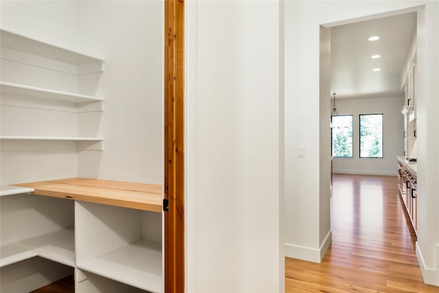 hallway with light hardwood / wood-style floors