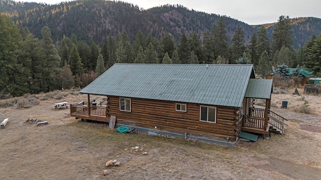 back of house with a deck with mountain view