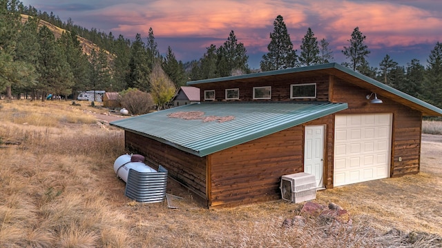 exterior space featuring a garage and an outdoor structure