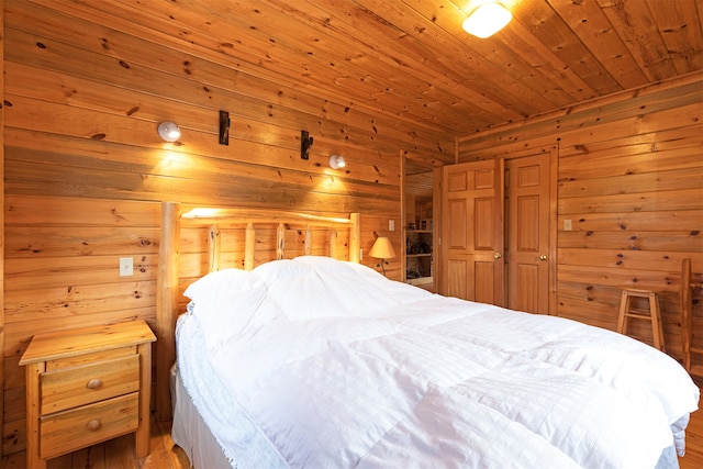 bedroom featuring wooden ceiling, wood-type flooring, and wooden walls