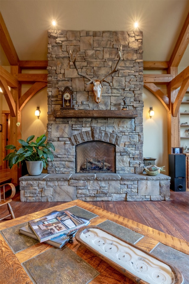 living room featuring a stone fireplace and hardwood / wood-style flooring