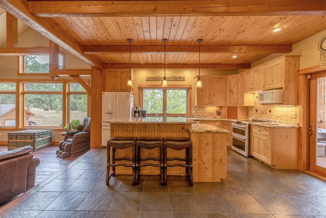 214 Solomon Mountain Rd, Clancy, MT 59634 - kitchen with white appliances, a wooden ceiling with exposed beams, a center island, backsplash, and light stone counters