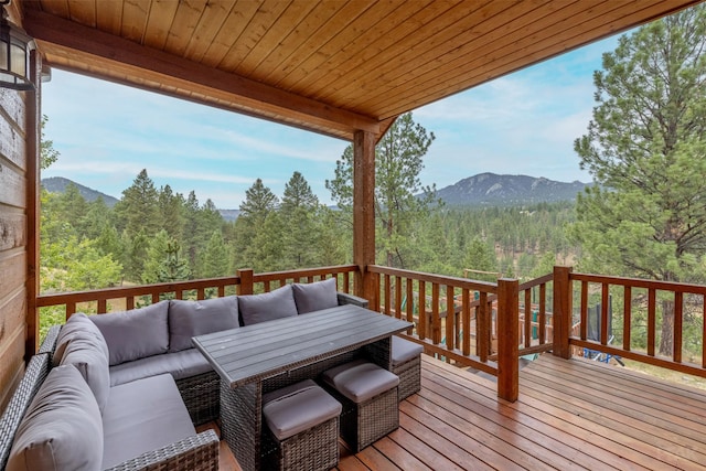 214 Solomon Mountain Rd, Clancy, MT 59634 - wooden deck featuring an outdoor hangout area, a view of trees, a mountain view, and outdoor dining space