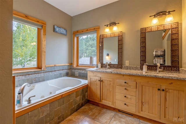 bathroom featuring vanity, tiled bath, and tile patterned floors