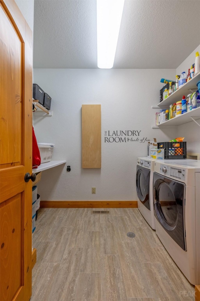 214 Solomon Mountain Rd, Clancy, MT 59634 - laundry room with independent washer and dryer, light wood finished floors, and a textured ceiling