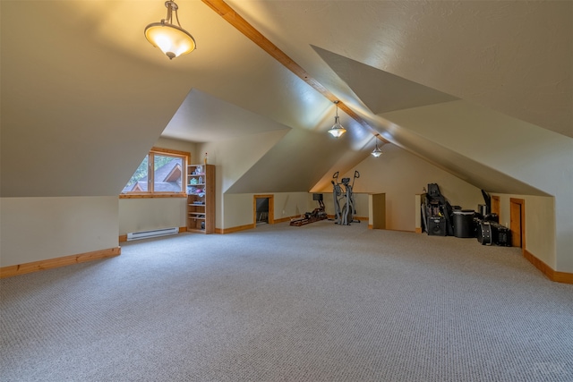 additional living space with lofted ceiling, a baseboard heating unit, and carpet floors