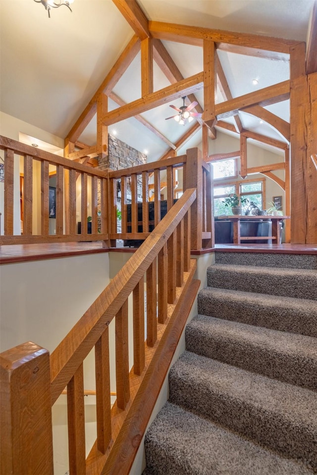 214 Solomon Mountain Rd, Clancy, MT 59634 - stairway featuring beam ceiling, ceiling fan, and high vaulted ceiling