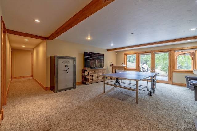 playroom with beam ceiling and light colored carpet