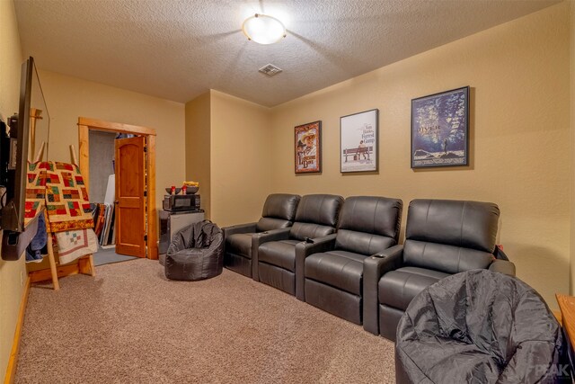 carpeted cinema room with a textured ceiling