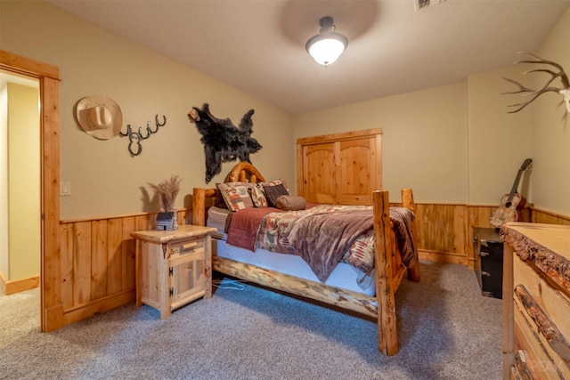 214 Solomon Mountain Rd, Clancy, MT 59634 - carpeted bedroom featuring wooden walls and a wainscoted wall
